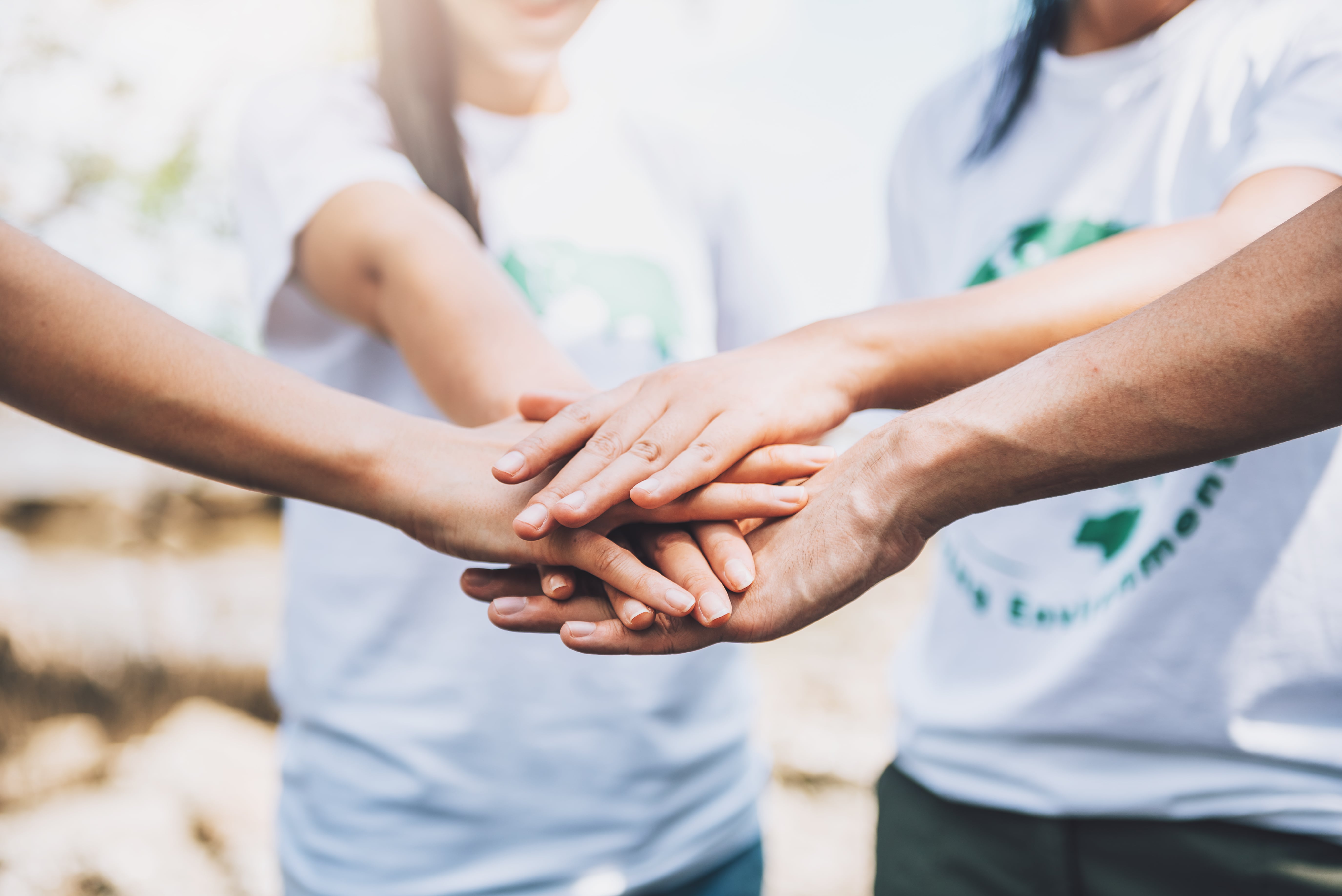 Close-up people volunteer teamwork putting finger star shape hands together stack hands unity teamwork world environment day